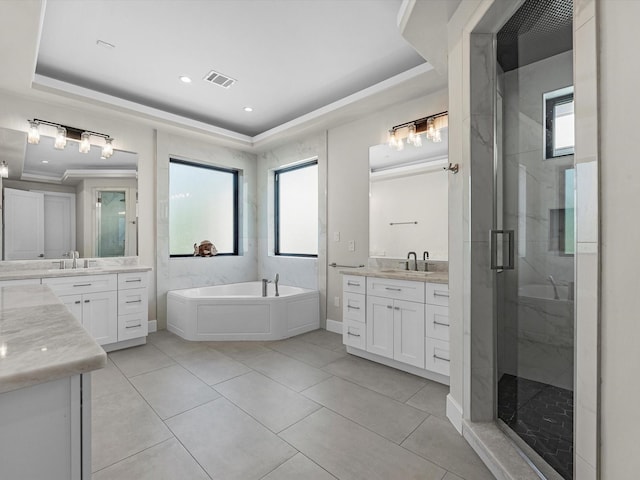 bathroom featuring tile patterned flooring, vanity, a raised ceiling, and independent shower and bath