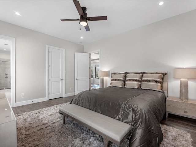 bedroom with ceiling fan, dark wood-type flooring, and ensuite bath