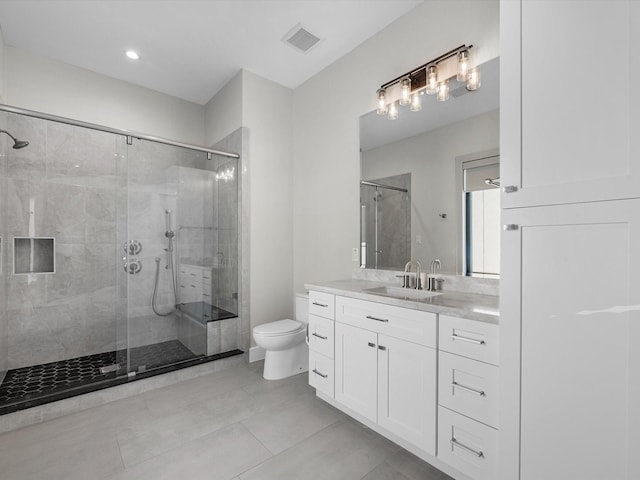 bathroom featuring walk in shower, tile patterned floors, vanity, and toilet