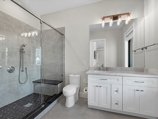 bathroom featuring an enclosed shower, vanity, tile patterned floors, and toilet