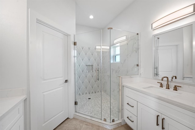 bathroom with vanity and a shower with door