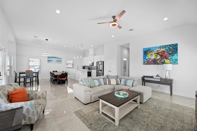 living room with sink and ceiling fan