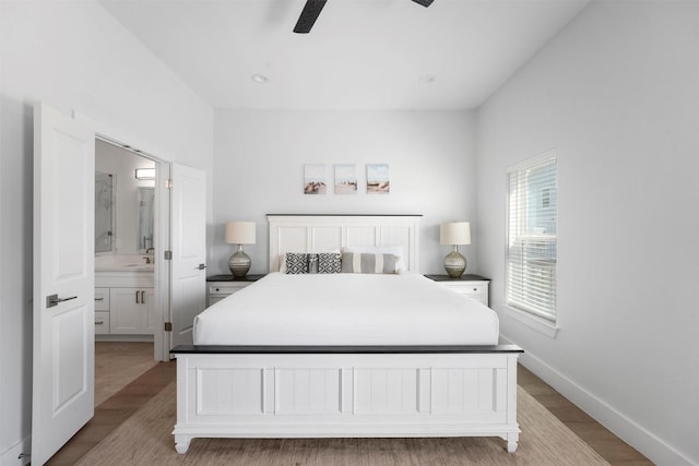 bedroom with sink, ensuite bath, ceiling fan, and light wood-type flooring