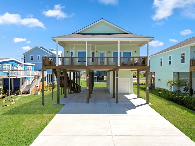 coastal inspired home with a garage, a carport, covered porch, and a front lawn