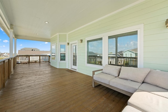 wooden terrace with an outdoor living space