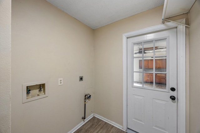 clothes washing area featuring hardwood / wood-style flooring, hookup for an electric dryer, and hookup for a washing machine