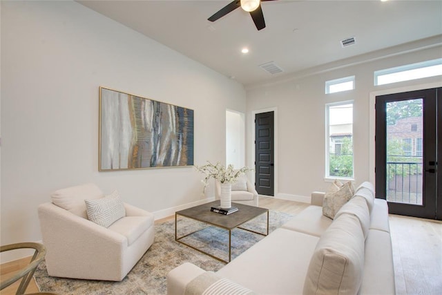 living room with ceiling fan and light hardwood / wood-style floors