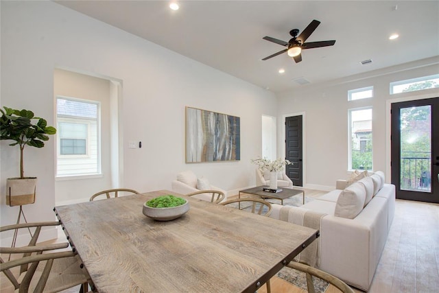 dining area with ceiling fan and light wood-type flooring