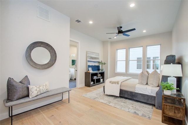 bedroom featuring connected bathroom, light hardwood / wood-style floors, and ceiling fan