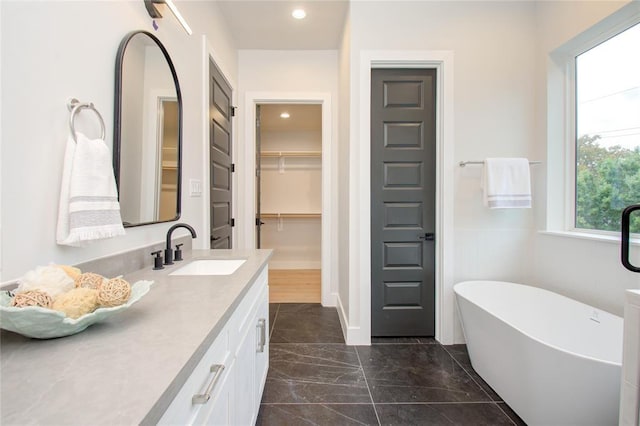 bathroom featuring vanity and a bath