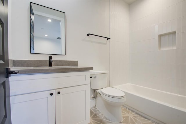 full bathroom with vanity, tiled shower / bath combo, and toilet