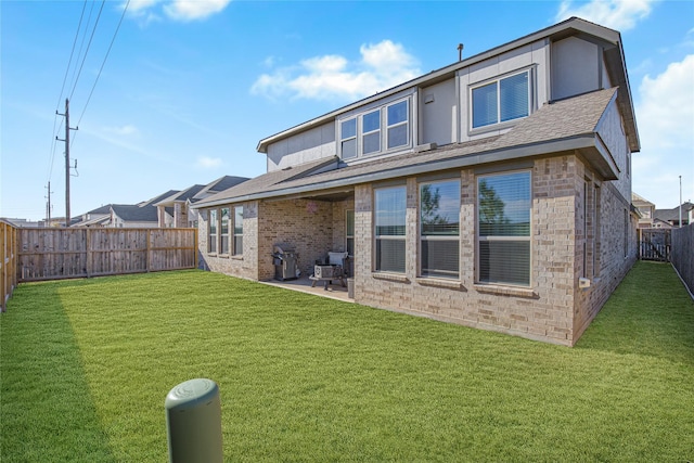 back of property featuring a patio and a yard