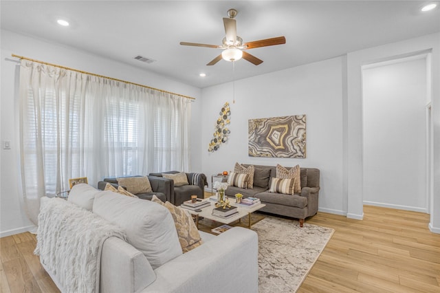 living room featuring ceiling fan and light hardwood / wood-style flooring