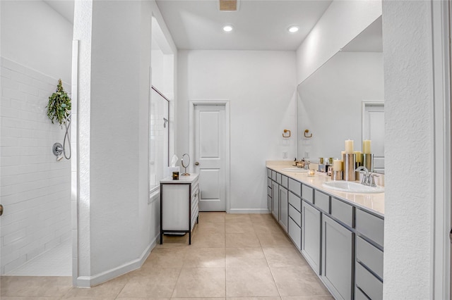 bathroom with tile patterned floors, vanity, and tiled shower