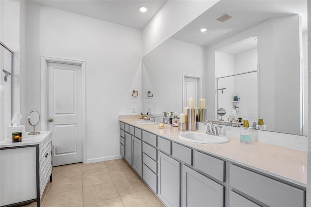 bathroom featuring tile patterned flooring, vanity, and an enclosed shower