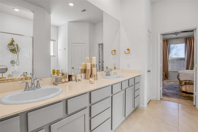 bathroom with a shower, tile patterned floors, vanity, and a wealth of natural light