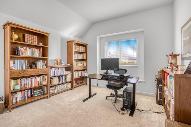 carpeted home office with vaulted ceiling