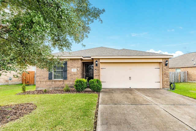 ranch-style house featuring a garage and a front yard