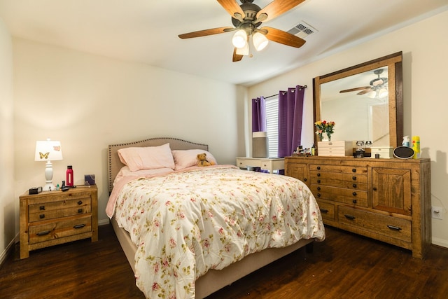 bedroom with ceiling fan and dark hardwood / wood-style flooring