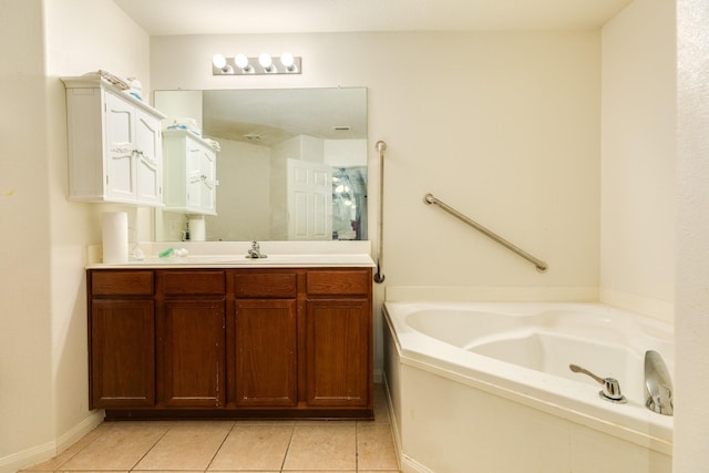 bathroom featuring vanity, tile patterned flooring, and a bathtub