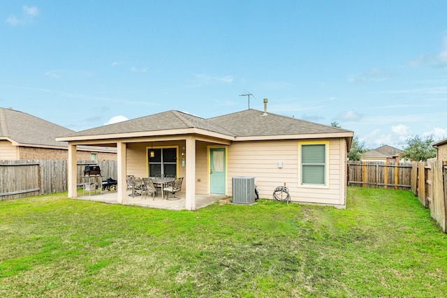 back of property featuring cooling unit, a yard, and a patio