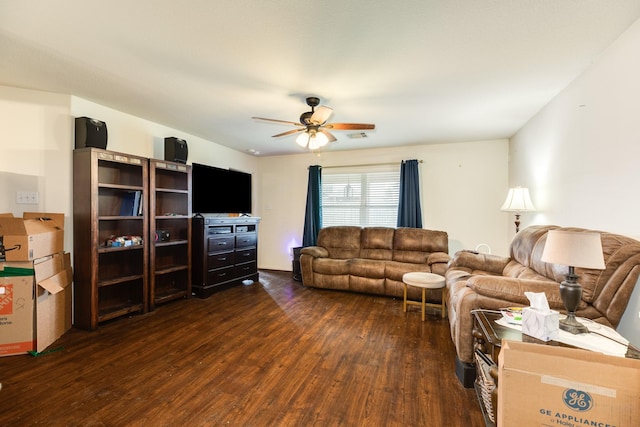 living room with dark wood-type flooring and ceiling fan