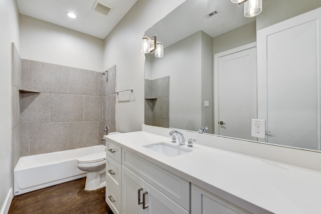 full bathroom featuring vanity, tiled shower / bath combo, concrete floors, and toilet