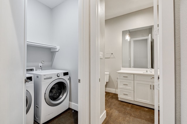 laundry area with sink and independent washer and dryer