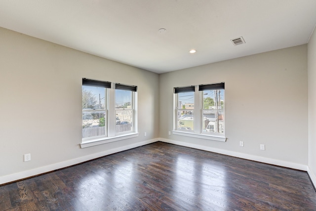 spare room featuring dark hardwood / wood-style flooring