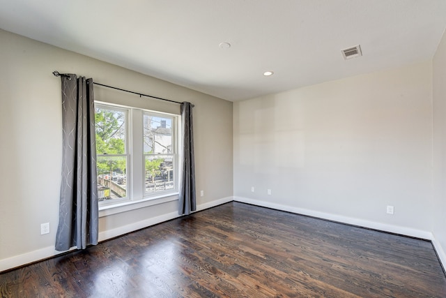 spare room with dark hardwood / wood-style floors