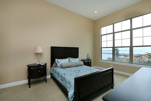 carpeted bedroom featuring a water view