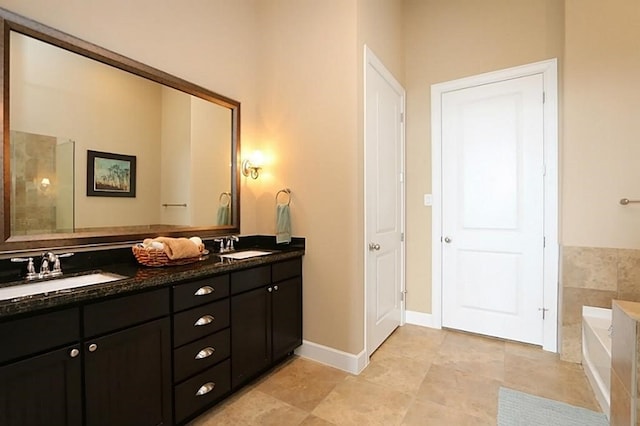 bathroom with vanity and a tub to relax in