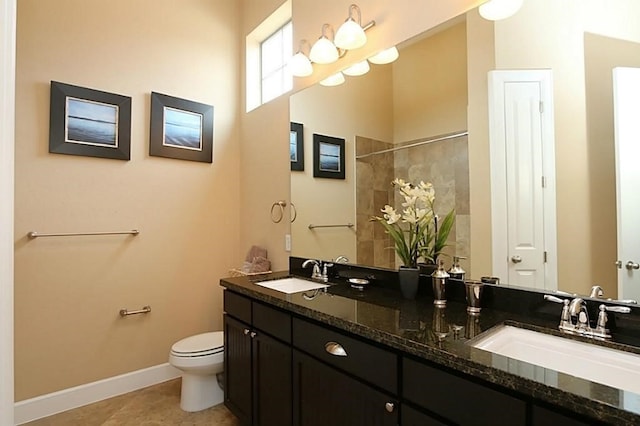 bathroom featuring vanity, walk in shower, tile patterned floors, and toilet