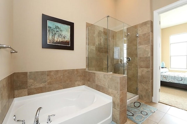 bathroom featuring tile patterned floors and separate shower and tub