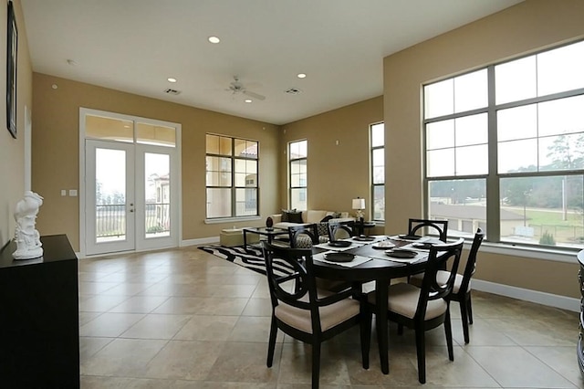 dining room with french doors and light tile patterned floors