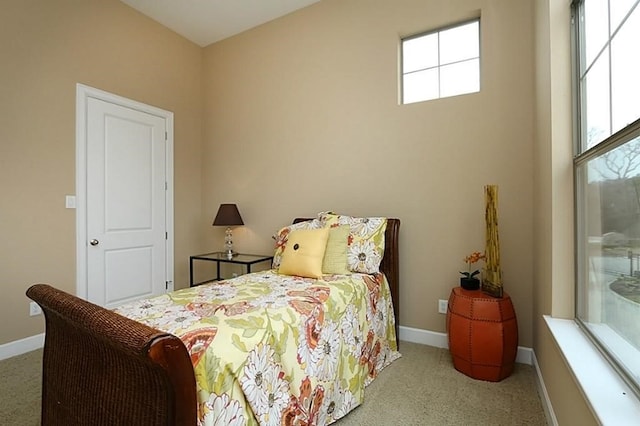 carpeted bedroom featuring multiple windows