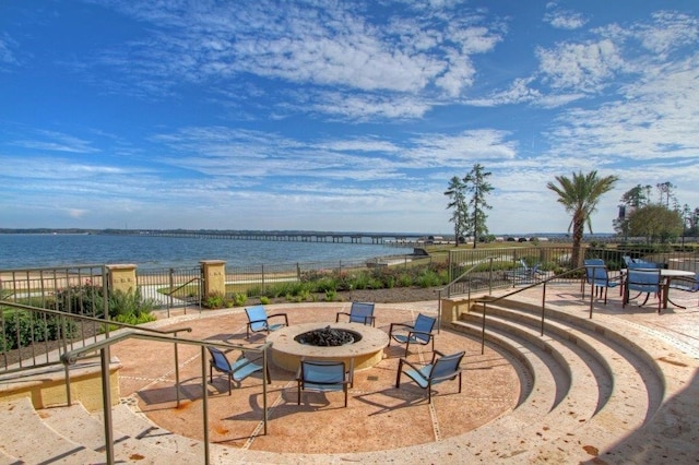 view of patio / terrace with a water view and a fire pit