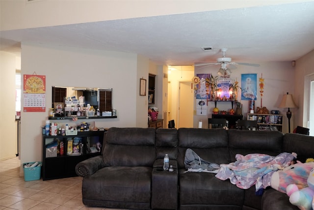 tiled living room with ceiling fan