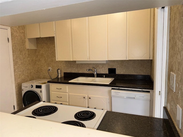 kitchen with range, white dishwasher, washer / dryer, and sink