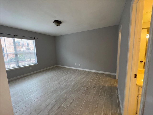 spare room with wood-type flooring