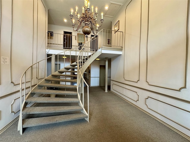 staircase with carpet flooring and a notable chandelier