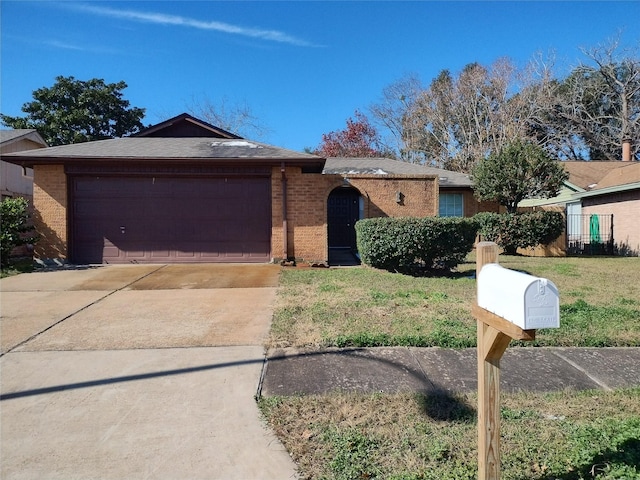 single story home with a garage and a front lawn