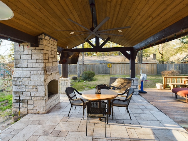 view of patio featuring ceiling fan and an outdoor stone fireplace