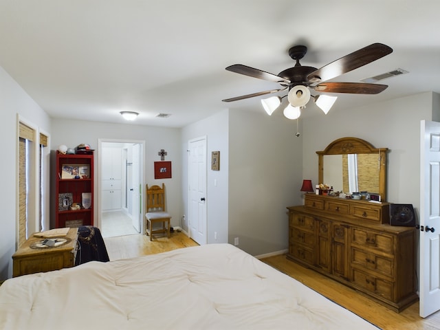 bedroom with ceiling fan and light hardwood / wood-style flooring