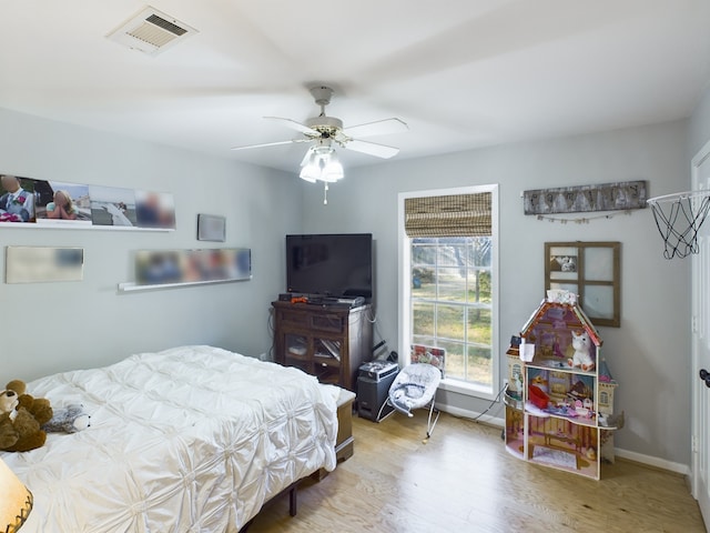 bedroom with ceiling fan and light wood-type flooring