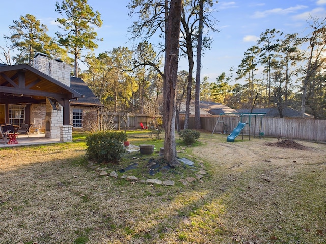 view of yard featuring a playground and a patio