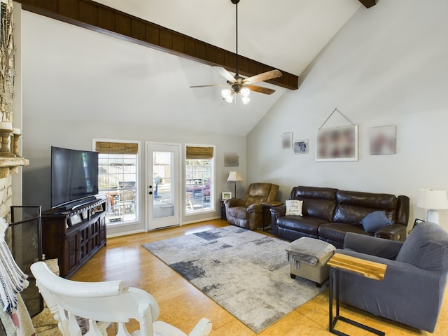 living room featuring a stone fireplace, high vaulted ceiling, beamed ceiling, and light wood-type flooring