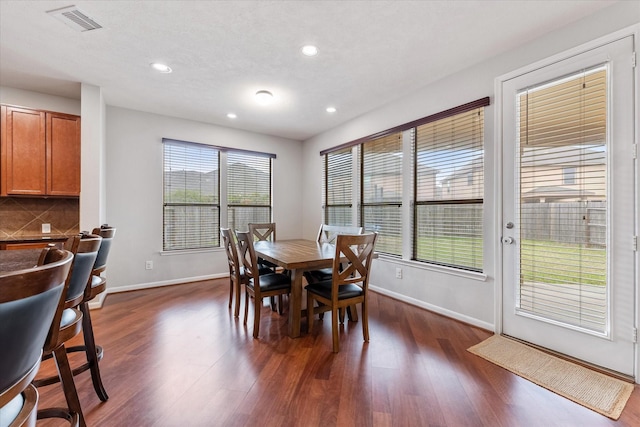 dining space featuring recessed lighting, dark wood finished floors, visible vents, and baseboards