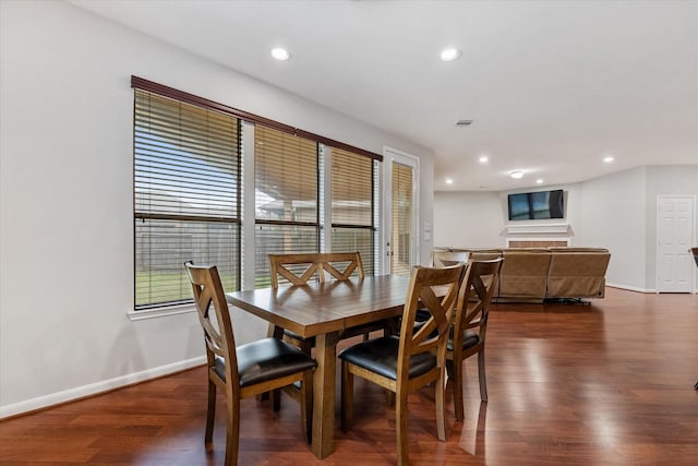 dining room with recessed lighting, dark wood finished floors, and baseboards