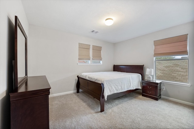 bedroom with light carpet, baseboards, and visible vents